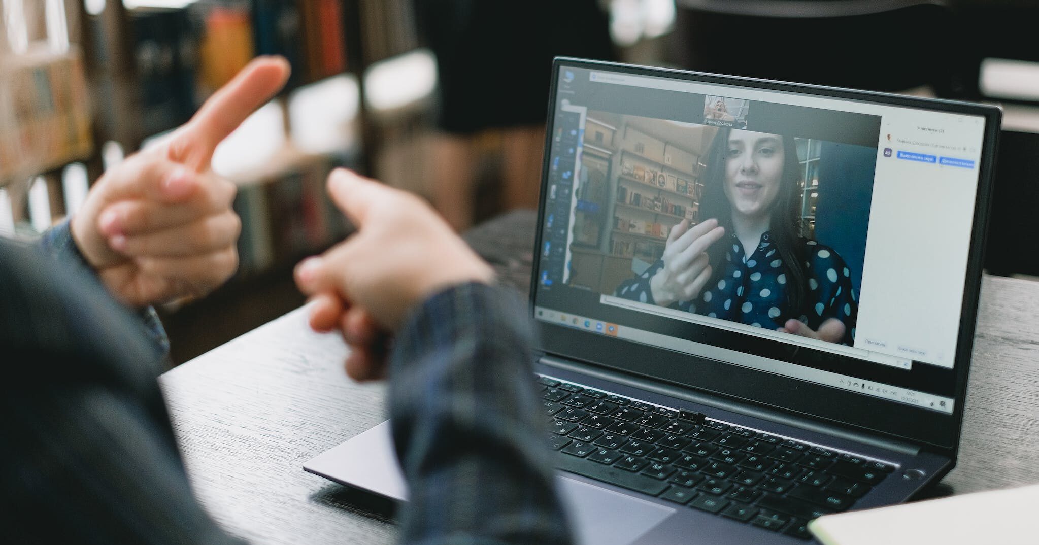 someone using American Sign Language with someone on a video call