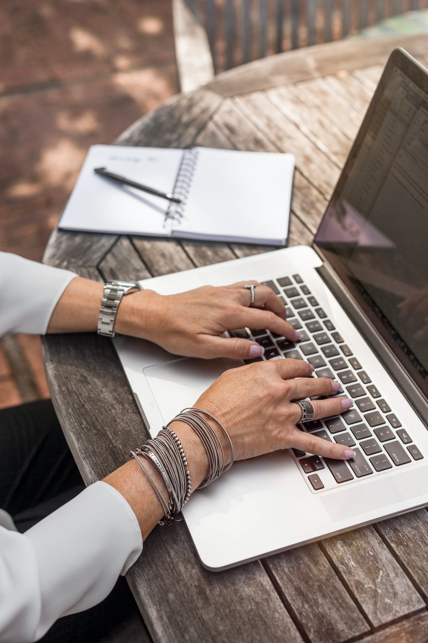 hands of a woman of colour typing on a laptop